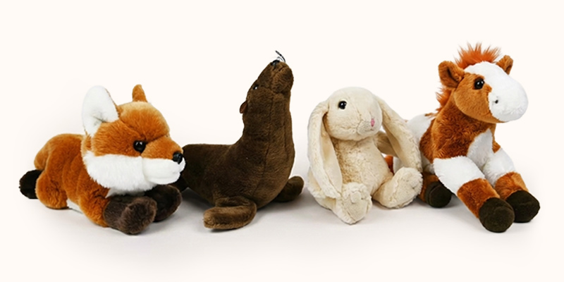 Four toy stuffed animals: a fox, seal, rabbit and horse.
