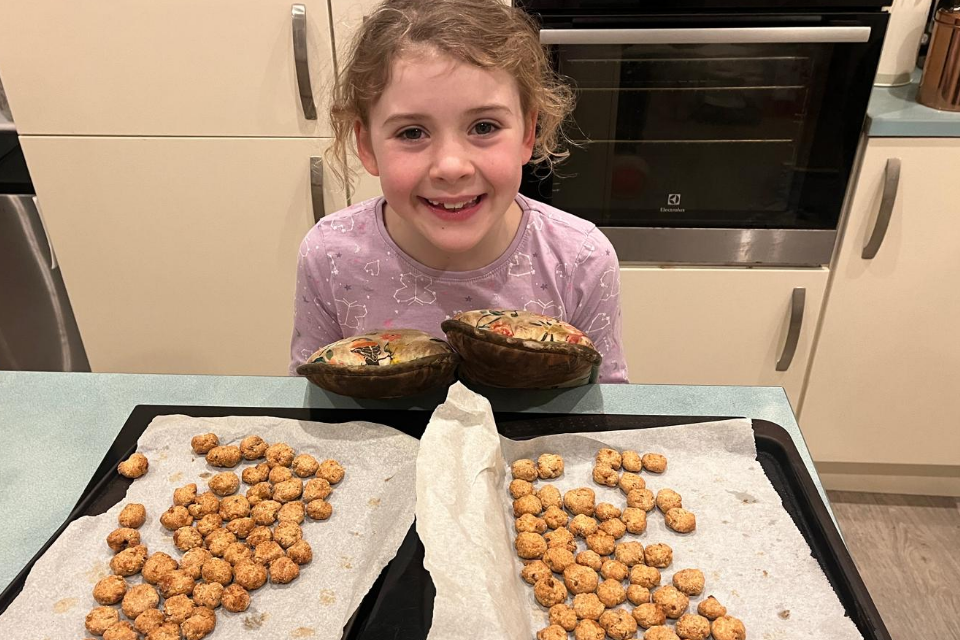 A young person baking treats for her cat