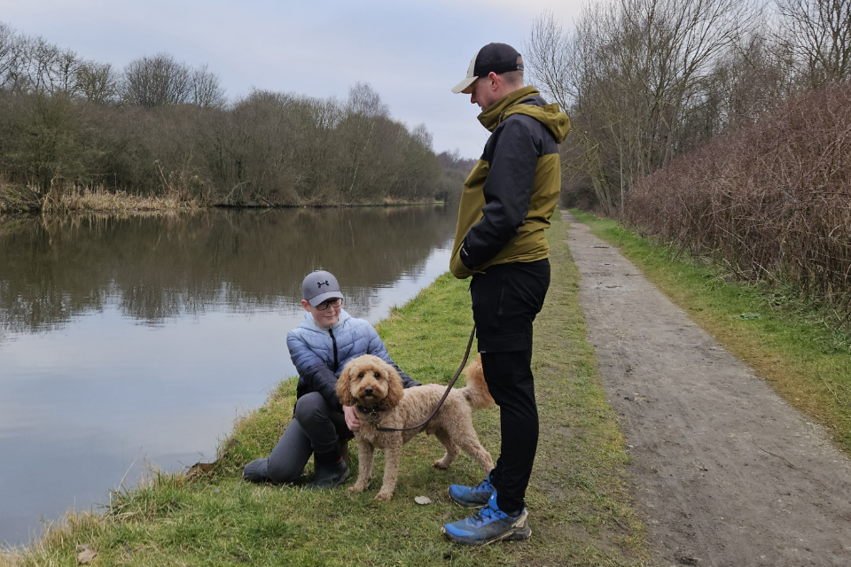 A young person taking their dog for a walk