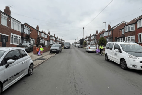 Young people on a road on the way to a litter pick.