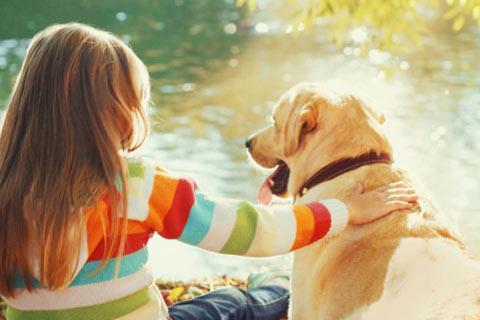 Young girl with her pet dog sitting together