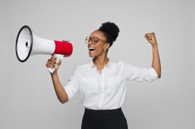 A lady with a megaphone, looking triumphant