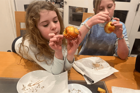 Two children making an apple seeded bird feeder