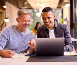 Two people looking at a laptop