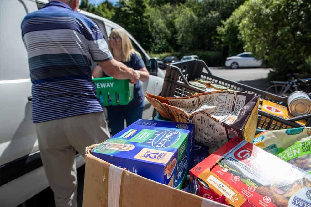 Volunteers helping to transport donated pet food.